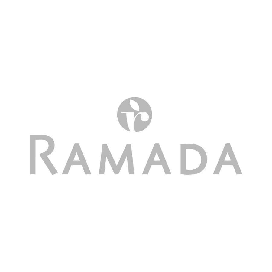 The image shows the word RAMADA in large gray capital letters with a circular logo featuring a stylized letter R and leaf design above the text, all on a light gray background.
